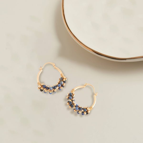 gold hoop beaded earrings. the hoops are small