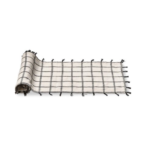 This white and black 100% cotton runner is slub woven with self tassles in black 
