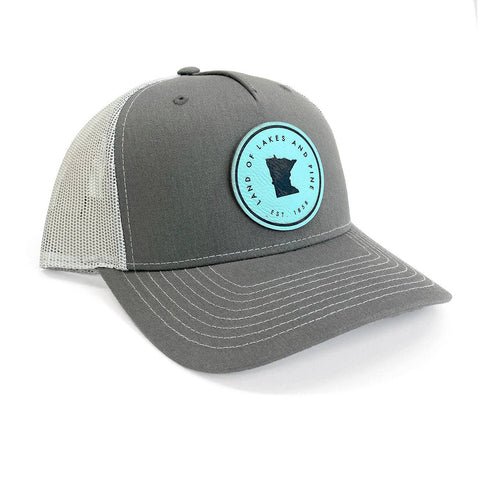 Gray and white cap with a teal and black "Land of Lakes and PIne" logo.