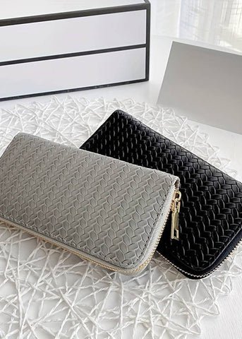 faux leather woven wallet.  can hold credit cards and cash and a few other items in the zippered area.